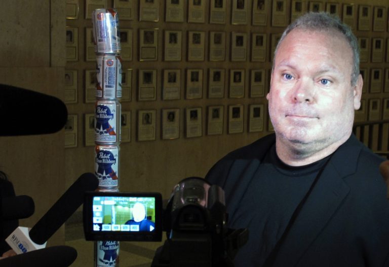 Chaz Stevens talks with reporters after setting up his Festivus pole made out of beer cans at the Florida Capitol building in Tallahassee, Fla., Wednesday, Dec. 11, 2013. 