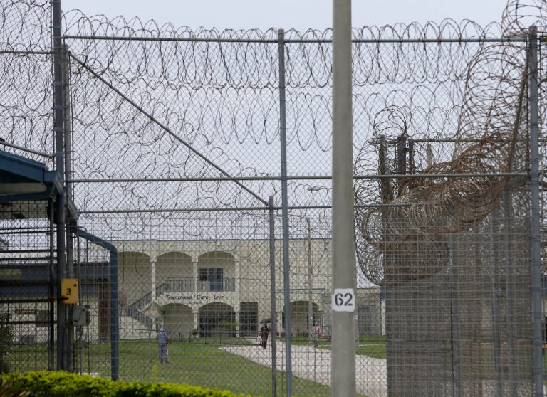 A prisoner works on the lawn at the Dade Correctional Institution in Florida City, Florida.