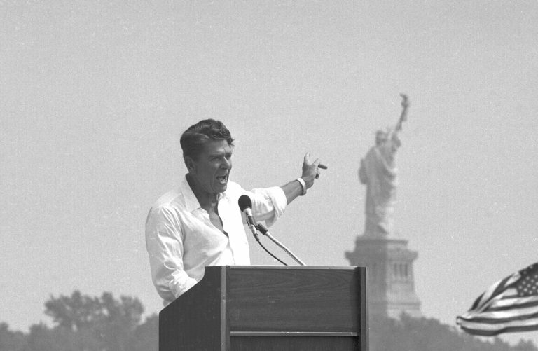 Republican presidential nominee Ronald Reagan points to the Statue of Liberty in New York Harbor in background as he campaigns with rolled up sleeves and an open shirt at Liberty State Park in Jersey City, N.J., Sept. 1, 1980. A new survey said he is the most admired of all recent presidents.