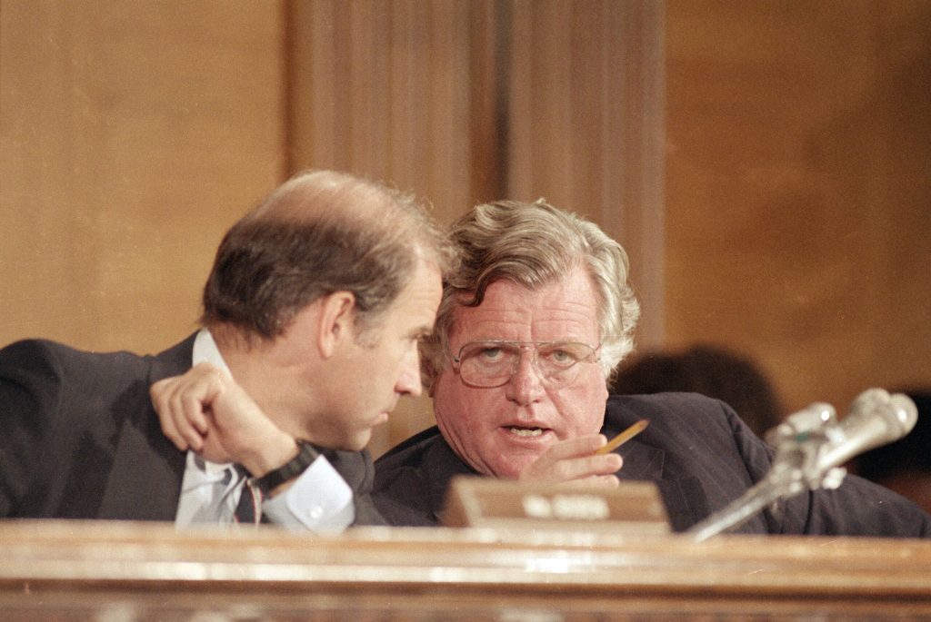 Ted Kennedy whispering in Biden’s ear