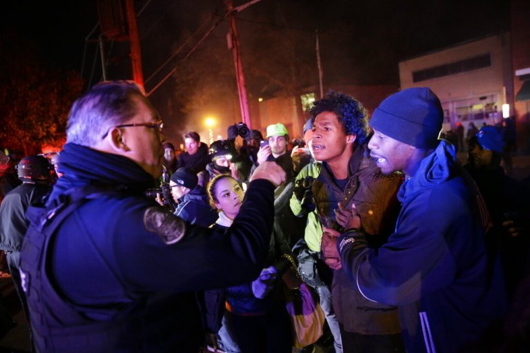Protesters confront a police officer on Nov. 25, 2014, in Ferguson, Missouri.