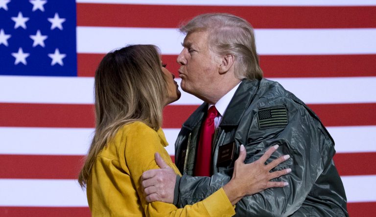 President Trump kisses first lady Melania Trump during a hanger rally at Al Asad Air Base, Iraq, Wednesday, Dec. 26, 2018.