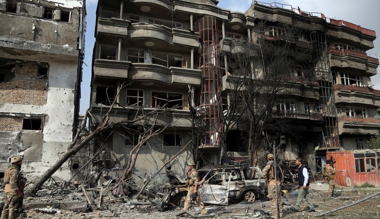 Afghan security forces inspect the aftermath of Sunday's attack in Kabul, Afghanistan, Monday, July 29, 2019.