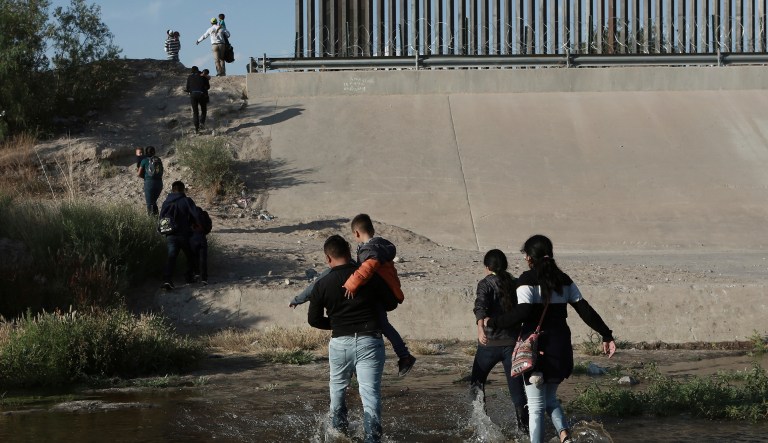 Migrant families cross the Rio Grande to get illegally across the border into the United States, to turn themselves in to authorities and ask for asylum, next to the Paso del Norte international bridge, near El Paso, Texas, Friday, May 31, 2019.