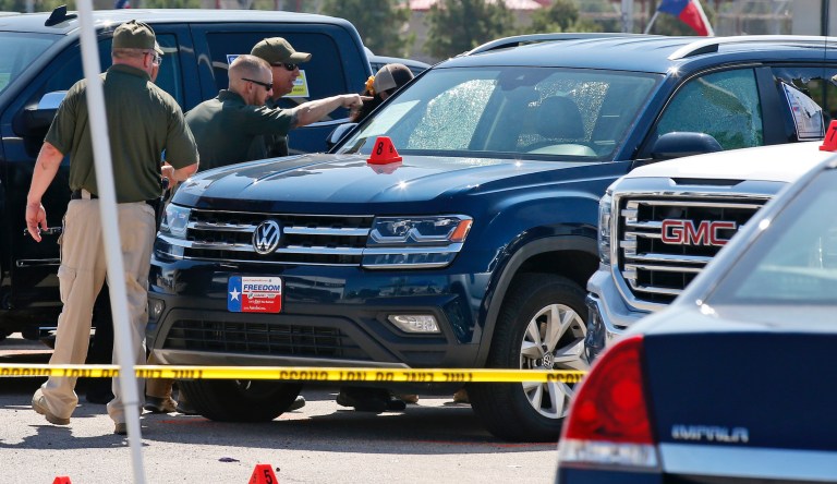 Officials continue to work the scene where 15-year-old Leilah Hernandez was shot and killed at a car dealership during Saturday's shooting incident Monday, Sept. 2, 2019, in Odessa, Texas.
