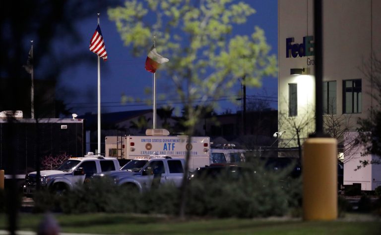 An ATF vehicle sits in front of a FedEx distribution center where a package exploded, Tuesday, March 20, 2018, in Schertz, Texas. Authorities believe the package bomb is linked to the recent string of Austin bombings.