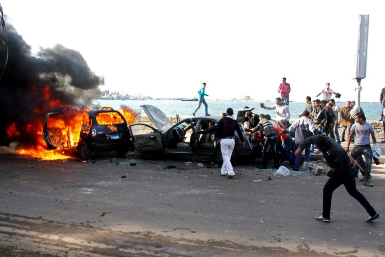   Cars burn during clashes between supporters and opponents of President Mohammed Morsi in Alexandria, Egypt, Friday, Dec. 14, 2012, a day before the referendum on the constitution. Opposing sides in Egypt's political crisis were staging rival rallies on Friday, the final day before voting starts on a contentious draft constitution that has plunged the country into turmoil and deeply divided the nation.(AP Photo/Ahmed Ramadan)  
