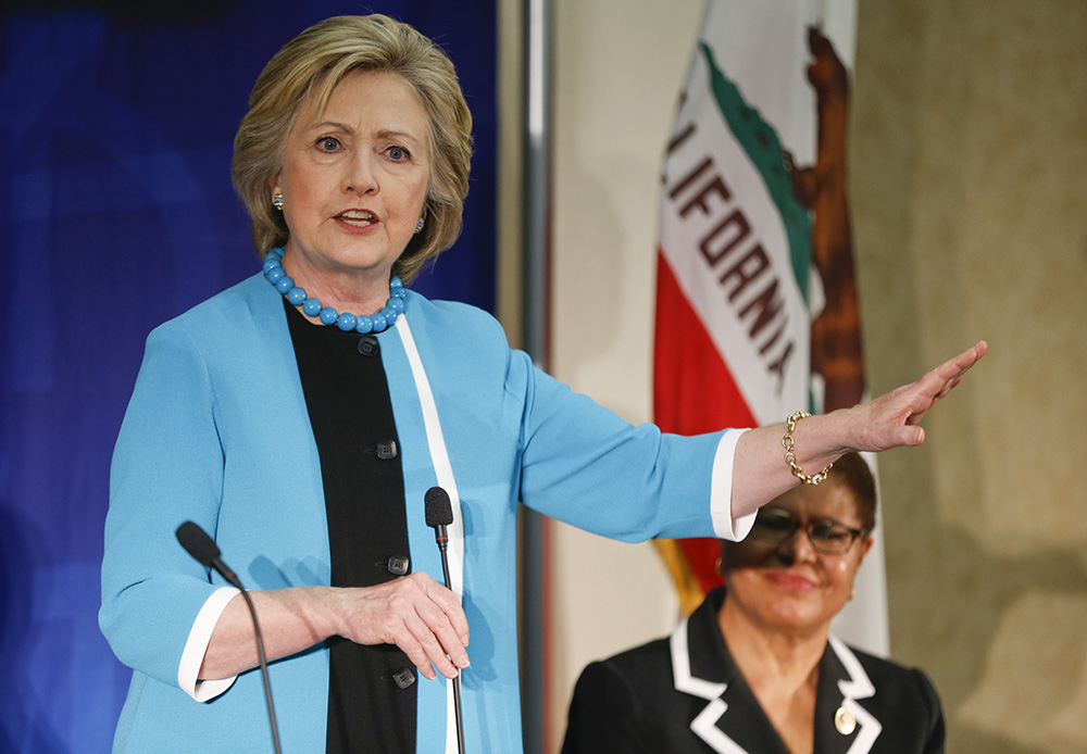 Clinton hits Trump but pro-Bernie protesters interrupt