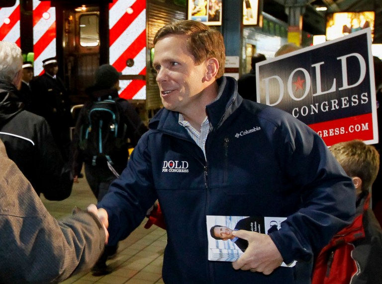 In this Nov. 5, 2012 photo, U.S. Rep. Bob Dold R-Ill., campaigns at a downtown Chicago commuter rail station during his unsuccessful re-election bid against Democrat Brad Schneider.  Schneider is running again to try an unseat Schneider in the November 2014 election. (AP Photo/Charles Rex Arbogast, File)