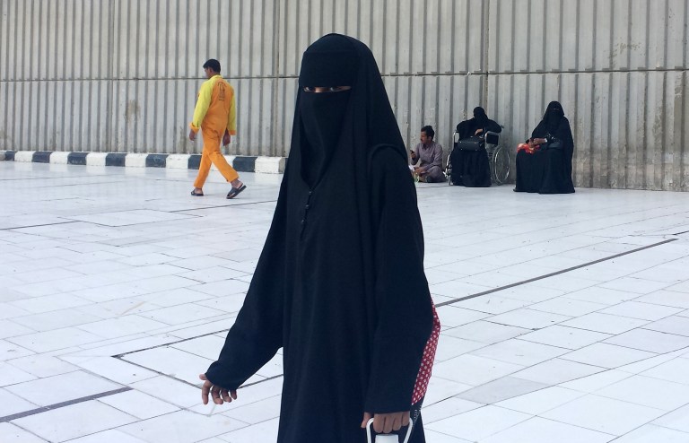 FILE - In this Monday, Dec. 9, 2013 file photo, a veiled woman walks in Mecca, Saudi Arabia. Thousands of Saudis vented their anger online over a report Thursday, Feb. 6, 2014, that staff at a Riyadh university had barred male paramedics from entering a women's-only campus to assist a student who had suffered a heart attack and later died. (AP Photo/Aya Batrawy, File)