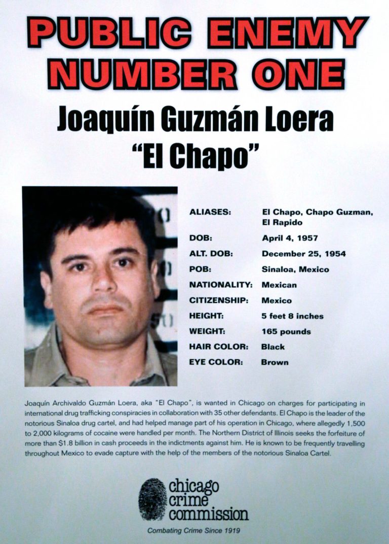 FILE - This Feb. 14, 2013 file photo, shows a poster displayed at a Chicago Crime Commission news conference in Chicago, where Joaquin ``El Chapo'' Guzman, a drug kingpin in Mexico, was named as Chicago's Public Enemy No. 1, It is first time since prohibition, when the label was created for Al Capone, that anyone else has been named Public Enemy No. 1. Ruthless drug cartels have long been the nation's No. 1 supplier of illegal drugs, but in the past, their operatives rarely ventured beyond the border. A wide-ranging Associated Press review of federal court cases and government drug-enforcement data, plus interviews with many top law enforcement officials, indicate the groups have begun deploying agents from their inner circles to the U.S. (AP Photo/M. Spencer Green, File)