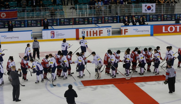 South, wearing white uniforms, and North Korean players shake hands after a women's ice hockey game in South Korea. During South and North Korea's talks at the border, senior officials from the two Koreas reached a package of deals including fielding a joint women's hockey team and conducting a joint march under a 
