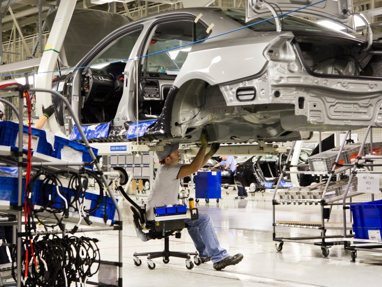 An employee works on a Passat sedan at the Volkswagen plant in Chattanooga, Tenn., in July 2012. (AP Photo/Erik Schelzig, file)