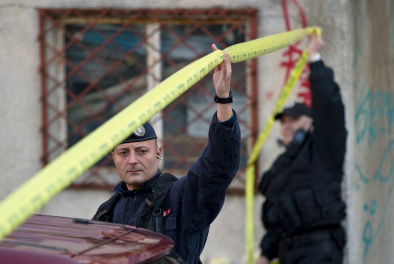 Riot policemen raise a police line outside the compound that housed the nightclub where a fire occurred in the early morning hours in Bucharest, Romania, Saturday, Oct. 31, 2015. (AP Photo/Vadim Ghirda)
