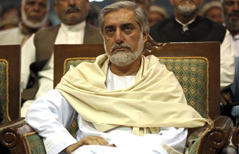 In this picture taken on Wednesday, June 11, 2014, Afghanistan's presidential candidate Abdullah Abdullah listens during his last campaign rally in Kabul, Afghanistan. Abdullah, a 53-year-old former foreign minister and former aide to a famed warlord during the Afghan anti-Soviet guerrilla campaign, was the runner-up in the 2009 disputed elections that were won by Karzai. (AP Photo/Massoud Hossaini)