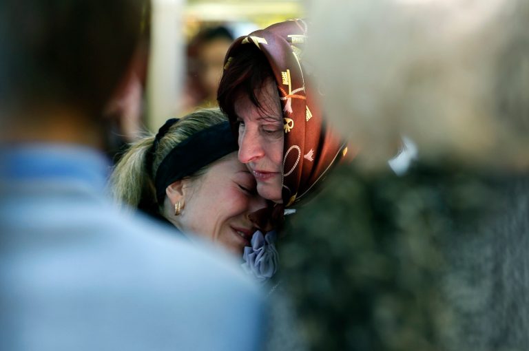Relatives mourn in front of the casket of a person killed during clashes between Ukrainian and pro-Russian forces last week, during a commemoration service in the center of Slovyansk, eastern Ukraine, Wednesday, May 7, 2014.  The U.S. and European nations have increased diplomatic efforts ahead of Ukraine's May 25 presidential election, as a pro-Russian insurgency continues to rock the country's eastern regions. (AP Photo/Darko Vojinovic)