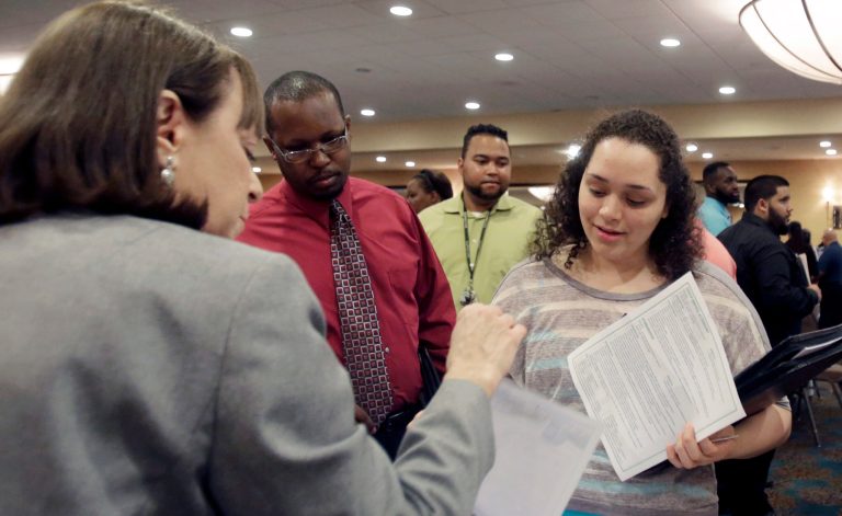 FILE - In this April 28, 2014 file photo, Natalie Silverstein, of the Broward County Transportation Department, left, explains the job openings at the County to job seeker Janely Ramos, right, during a job fair in Fort Lauderdale, Fla. The Labor Department releases job openings and labor turnover survey for March on Friday, May 9, 2014. (AP Photo/Alan Diaz, File)