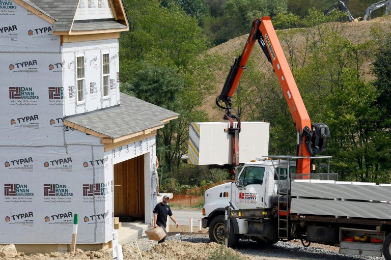 In this Wednesday, Sept. 10, 2014 photo, a crane lifts a load of drywall as construction is under way at a housing development in Zelienople, Pa.  The National Association of Home Builders reports on sentiment among U.S. builders on Wednesday, Sept. 17, 2014. (AP Photo/Keith Srakocic)