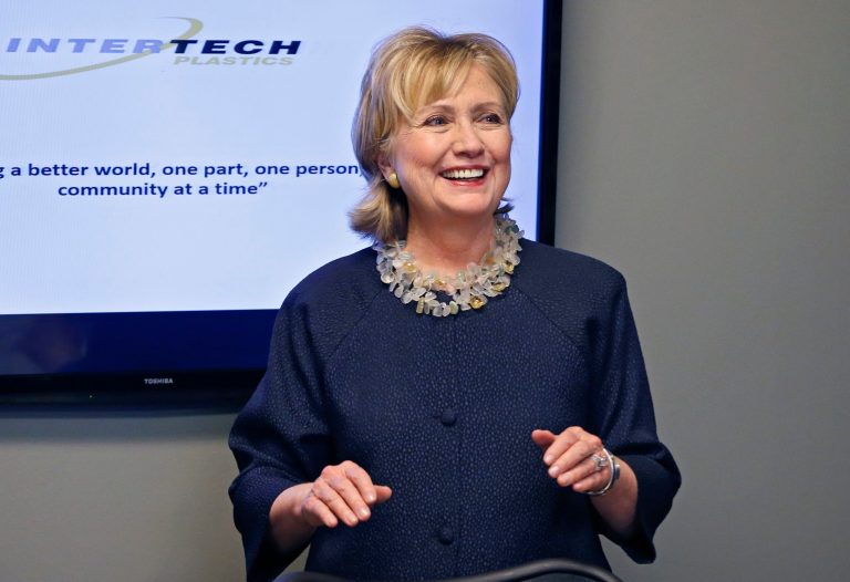 Hillary Clinton smiles at the start of a meeting with community leaders following a tour at Intertech Plastics in Denver on Monday. (AP/Brennan Linsley)