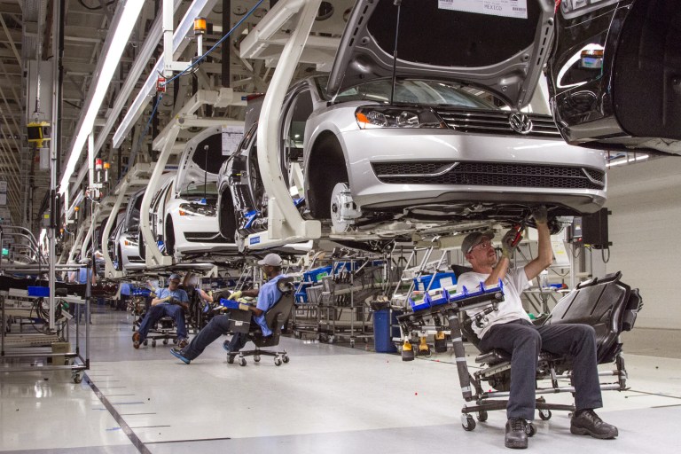 FILE - In this July 12, 2013, photo, employees at the Volkswagen plant in Chattanooga, Tenn., work on the assembly of a Passat sedan. Volkswagen on Monday, July 14, 2014 said it will build a new seven-passenger SUV at the Chattanooga factory, adding about 2,000 jobs. (AP Photo/Erik Schelzig, File)