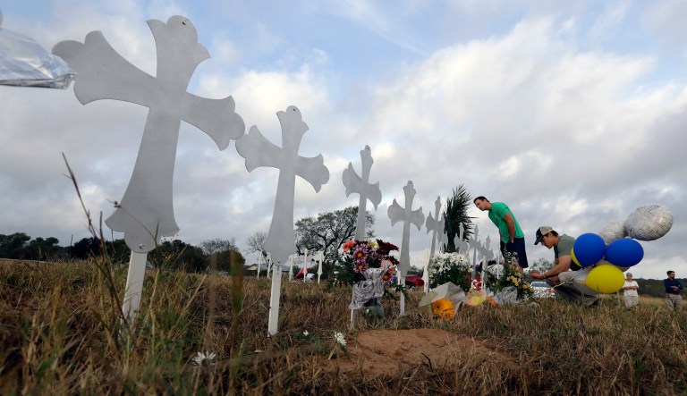 People visit a makeshift memorial for victims near the scene of a shooting at the First Baptist Church of Sutherland Springs, Texas. A husband and wife who survived Sunday's shooting said they heard what sounded like 