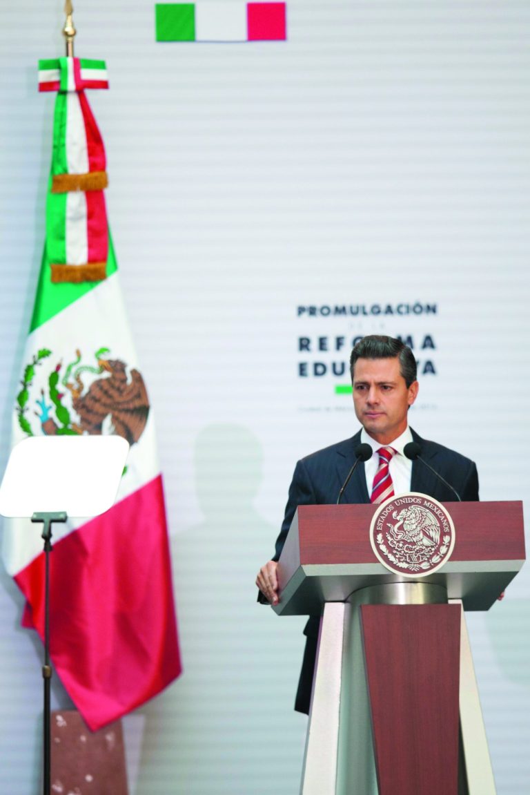 Mexico's President Enrique Pena Nieto pauses during a speech at the National Palace where he signed into law a plan to overhaul his country's public education system, in Mexico City, Monday, Feb. 25, 2013. The law which was approved by Congress in December, calls for creation of a professional system for hiring, evaluating and promoting teachers without the 