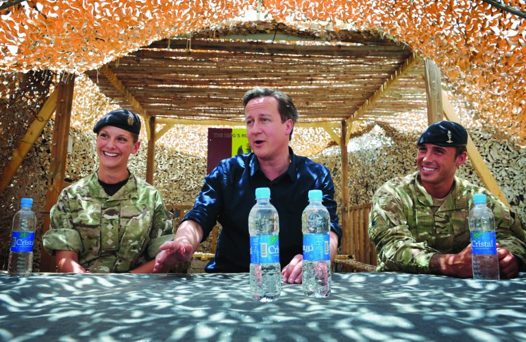 Britain's Prime Minister, David Cameron, has a drink and a chat with British soldiers (names not given) based at Lashkar Gah in Helmand Province, Afghanistan, Wednesday, July 18, 2012 during a surprise trip to the area. Earlier he met Afghan National Police chiefs. (AP Photo/Stefan Rousseau, Pool)