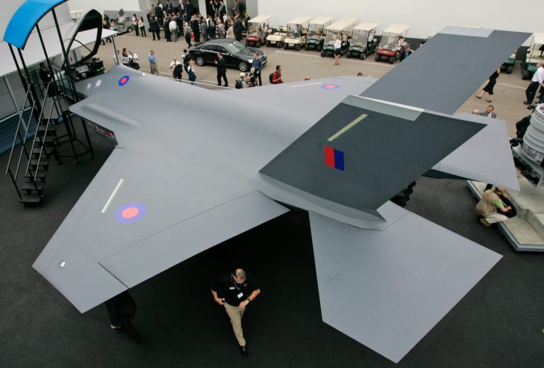 FILE - In this file photograph taken July 15, 2008, people wander around a life-size model of US planemaker Lockheed Martin's F-35 Lightning Joint Strike Fighter II, during the Farnborough aerospace show, in Farnborough, England. A lot is at stake in the Farnborough International Airshow, the aviation industry's biggest annual event which opens Monday, July 14, 2014. The trade show is expected to see the first presentation of the world's most advanced fighter jet, new commercial aircraft as well as a host of new technological advances that promise to give a glimpse of the future of flying. (AP Photo/Lefteris Pitarakis, file)
