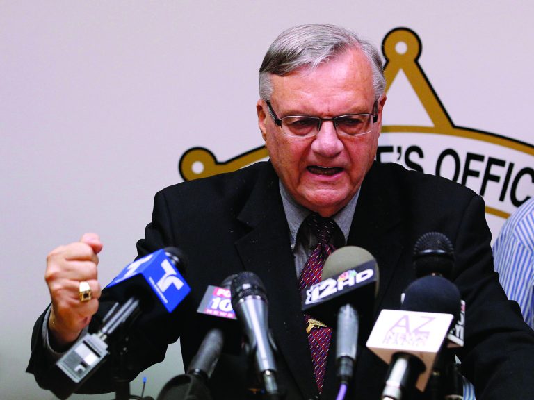 FILE - In this May 10, 2012 file photo, a defiant Maricopa County Sheriff Joe Arpaio pounds his fist on the podium as he answers questions regarding the Department of Justice announcing a federal civil lawsuit against Arpaio and his department, during a news conference in Phoenix. For six years, the self-proclaimed toughest sheriff in America has vehemently denied allegations that his deputies racially profile Latinos in his trademark immigration patrols. Now, Arpaio will have to convince a federal judge who is presiding over a lawsuit that heads to trial on Thursday, July 19, 2012 and is expected to last until early August. (AP Photo/Ross D. Franklin, File)