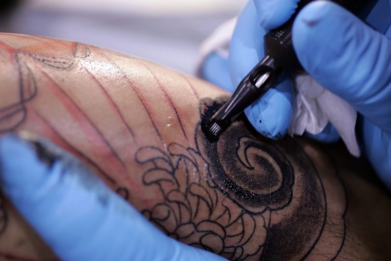 FILE - This Jsn. 6, 2006, file photo shows a tattoo artist from Los Angels during the Body Art Expo at the Los Angeles county fairgrounds in Pomona, Calif. Thinking about getting inked? Check the bottle first. The Food and Drug Administration is warning tattoo parlors, their customers and those buying at-home tattoo kits that not all tattoo ink is safe. (AP Photo/Chris Carlson, File)