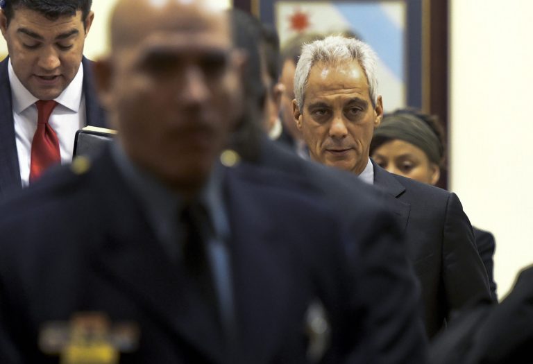 Chicago Mayor Rahm Emanuel, right, walks into city council chambers on Wednesday, Jan. 25, 2017, in Chicago. After the session he held a press conference where sanctuary cities, which don't arrest or detain immigrants living in the U.S. illegally, and Chicago violence, two issues raised by President Donald Trump, were discussed. (AP Photo/Matt Marton)