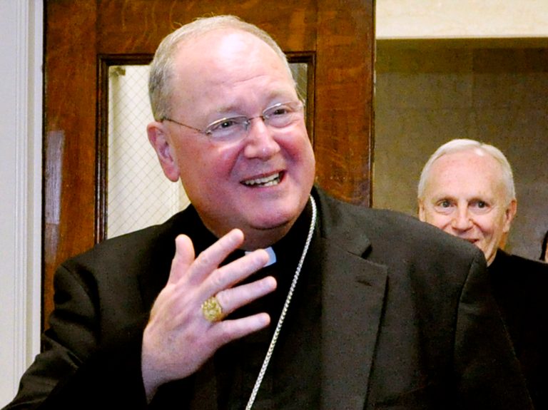FILE - In this March 12, 2012 file photo, Cardinal Timothy Dolan leaves a meeting at the New York State Capitol in Albany, N.Y. Dolan says he's now giving the closing prayer at both the Democratic and Republican conventions. The New York Roman Catholic leader made the announcement Tuesday through his spokesman.   (AP Photo/Stewart Cairns, File)