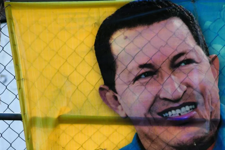 A boy plays behind a poster with an image depicting Venezuela's President Hugo Chavez in Caracas, Venezuela, Thursday, Jan. 3, 2013. The ailing president's health crisis has raised contentious questions ahead of the swearing-in set for Jan. 10, including whether the inauguration could legally be postponed. The ailing president's health crisis has raised contentious questions ahead of the swearing-in set for Jan. 10, including whether the inauguration could legally be postponed. Officials have raised the possibility that Chavez might not be well enough to take the oath of office, without saying what will happen if he can't. The constitution says that if a president or president-elect dies or is declared unable to continue in office, presidential powers should be held temporarily by the president of the National Assembly and that a new presidential vote should be held within 30 days. (AP Photo/Ariana Cubillos)