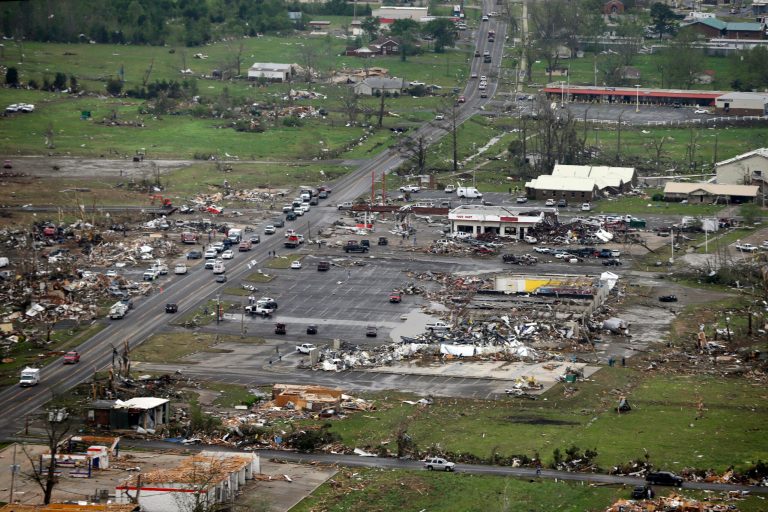 FILE - This Monday, April 28, 2014 aerial photo shows destroyed buildings and debris along U.S. Highway 64 in Vilonia, Ark. Vilonia was hit hard Sunday for the second time in three years. Four people were killed in a 2011 storm. Until this late April 2014 outbreak, the U.S. as a whole had by far the quietest start of the year for tornadoes. Longer trends show more tornado clusters recently. (AP Photo/Danny Johnston)