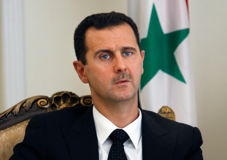FILE - This Wednesday, Aug. 19, 2009 file photo shows Syrian President Bashar Assad, seen, during a meeting with his Iranian counterpart Mahmoud Ahmadinejad, unseen, at the presidency in Tehran, Iran. Syrian President Bashar Assad says he won't step down before elections are held in his war-ravaged country. The Syrian leader's comments, published Saturday in the Argentine newspaper Clarin, highlight the difficulties the U.S. and Russia face in getting the Assad regime and Syria's political opposition to the table at an international conference envisioned for next month. (AP Photo/Vahid Salemi, File)