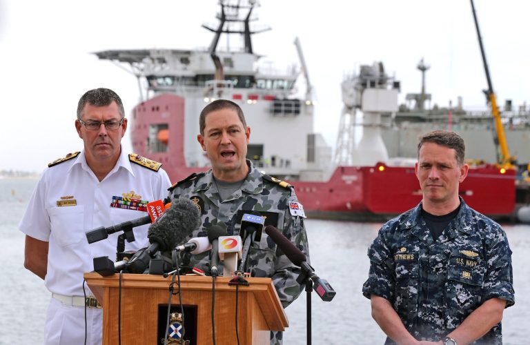 U.S. Navy Captain Mark Matthews right, Royal Australian Navy Commodore Peter Leavy commander of join task force 658, center, and Chief of the Navy Vice Admiral Ray Griggs speak at a press conference at naval base HMAS Stirling about the Defense ship Ocean Shield and her roll in the search for missing Malaysia Airlines Flight MH370 in Perth, Australia, Sunday, March 30, 2014.(AP Photo/Rob Griffith)