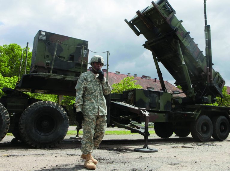 FILE - In this May 26, 2010 file photo, a U.S. soldier stands next to a Patriot surface-to-air missile battery at an army base in Morag, Poland. Turkey's government requested the deployment of NATO's Patriot surface-to-air missiles on Wednesday, Nov. 21, 2012 to bolster its defenses along its border with Syria and prevent a spillover of the civil war in that nation, officials said. (AP Photo/Czarek Sokolowski, File)