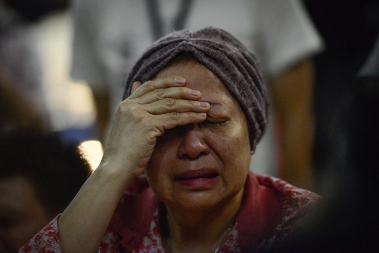 A woman reacts after hearing about the Malaysia Airlines passenger plane crashing in eastern Ukraine at Kuala Lumpur International Airport in Sepang, Malaysia, Friday, July 18, 2014.  Malaysia Airlines said it lost contact with Flight 17 over Ukrainian airspace Thursday. It was flying from Amsterdam to Kuala Lumpur, Malaysia. (AP Photo/Joshua Paul)