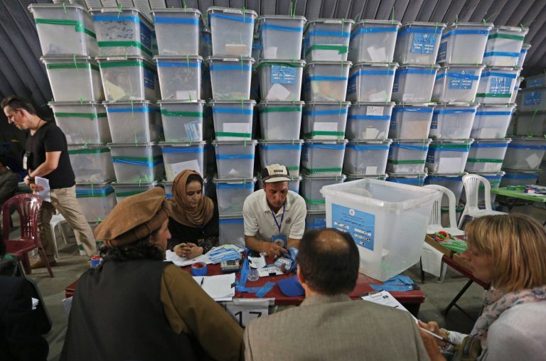 Afghan election commission workers sort ballot papers for an audit of the presidential run-off votes at an election commission office in Kabul, Afghanistan, Sunday, Aug. 3, 2014. An audit of results from Afghanistan's presidential runoff election resumed Sunday after a holiday break, an electoral official said. (AP Photo/Rahmat Gul)