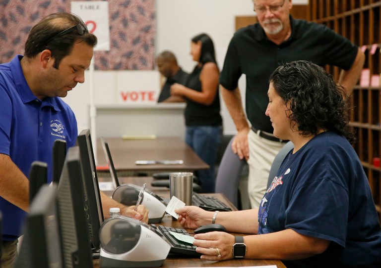 The U.S. Commission on Civil Rights voted Friday to condemn all state voter identification laws as racially discriminatory. (AP Photo/Sue Ogrocki)