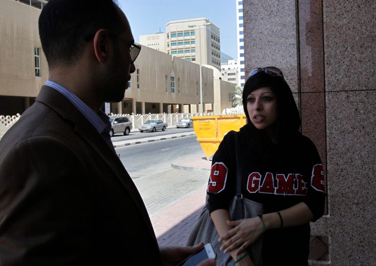 Bahraini opposition activist Zainab al-Khawaja, right, speaks to lawyer Mohammed al-Jishi about her detained sister, Maryam al-Khawaja, outside the court in Manama, Bahrain, Saturday, Sept. 6, 2014. A defense lawyer said a Bahraini court has ordered human rights activist Maryam al-Khawaja to remain in detention for a further 10 days as authorities continue to investigate her case. (AP Photo/Hasan Jamali)