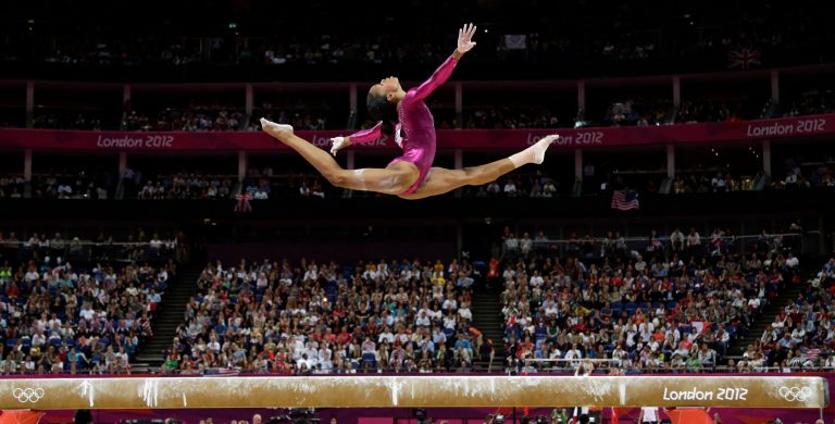   FILE - In this Aug. 2, 2012, file photo, Gabrielle Douglas, of the United States, performs on the balance beam during the artistic gymnastics women's individual all-around competition at the 2012 Summer Olympics in London. Douglas, who became the first African-American gymnast to claim gymnasticsâ biggest prize _ the all-around Olympic title _ is The Associated Pressâ 2012 female athlete of the year. (AP Photo/Gregory Bull, File)  