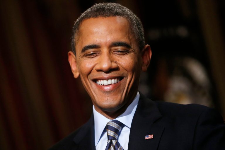 In this photo taken Friday, Oct. 4, 2013, President Barack Obama smiles during an exclusive interview with The Associated Press in the White House library in Washington, four days into a partial shutdown of the federal government that has forced 800,000 people off the job, closed national parks and curbed many government services. The deadline for keeping the government open coincided with the Oct. 1 start of sign-ups for the insurance markets at the center of the health care overhaul Obama signed into law during his first term. Government websites struggled in the first week to keep up with high demand for the new marketplaces. It's not clear that more than a few managed to enroll the first day. (AP Photo/Charles Dharapak)