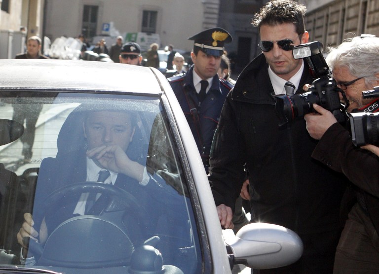 Florence Mayor and Italian center-left Democratic Party leader Matteo Renzi drives away as he is chased by reporters following a meeting with Premier Enrico Letta at Chigi Palace government office, in Rome, Wednesday, Feb. 12, 2014. Letta battled Wednesday to stay in office amid a power play by supporters of the dynamic head of his party, Renzi, to replace him as premier in the latest chapter to convulse Italy's fragile political stability. Renzi arrived at Letta's office at Palazzo Chigi for a make-or-break meeting ahead of a Democratic Party summit on Thursday that is expected to determine the government's next steps. (AP Photo/Riccardo De Luca)