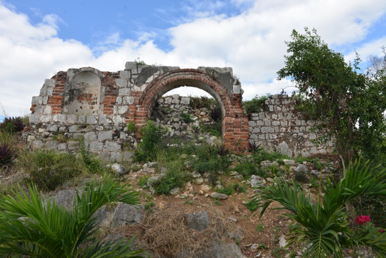 In this Jan. 4, 2013 photo, the ruins of a stone house where Rastafarian founding father Leonard P. Howell resided in the 1940s stands in ruins in Sligoville, Jamaica. Rastas are fighting to keep a developer from building on this hilltop, considered sacred to Rastas in southern Jamaica and dubbed 