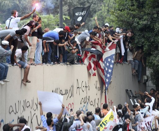 Protesters destroy an American flag pulled down from the U.S. embassy in Cairo. (AP Photo)