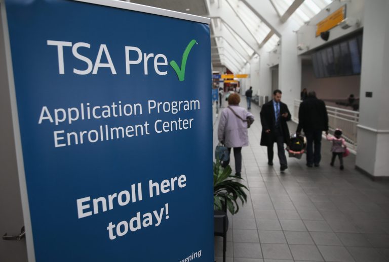 The TSA PreCheck program allows individuals who have passed prior background checks to move quickly through designated lanes of airport security so that security agents can focus on travelers going through the regular lanes.Â (John Moore/Getty Images)