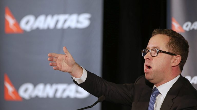 Qantas chief executive Alan Joyce announces a first-half loss of 235 million Australian dollars ($211 million) during a press conference in Sydney, Thursday, Feb. 27, 2014. The Australian flag carrier said the 5,000 jobs would be cut as part of its bid to cut AU$2 billion in costs over three years. (AP Photo/Rick Rycroft)