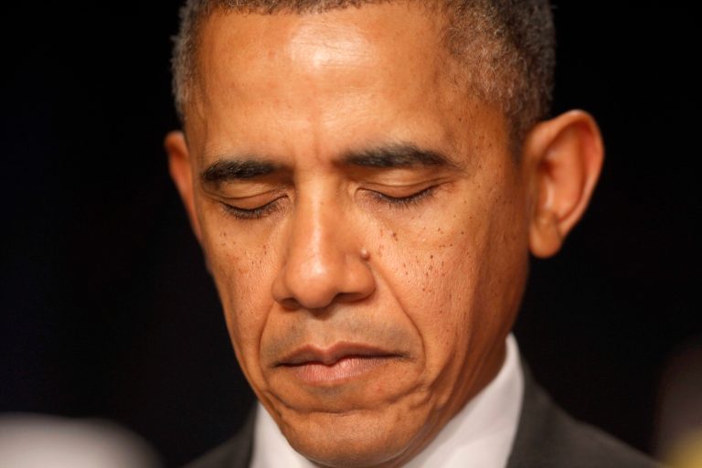 President Barack Obama closes his eyes as a prayer is offered at the National Prayer Breakfast in Washington, Thursday, Feb. 6, 2014. (AP Photo/Charles Dharapak)