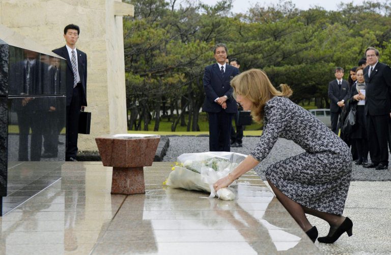 U.S. Ambassador  Caroline Kennedy offers flowers in front of the National War Dead Peace Mausoleum at the Peace Memorial Park in Itoman, Okinawa Wednesday, Feb. 12, 2014. Kennedy,who arrived later Tuesday, is to meet with Okinawan officials and may see the base relocation site during her three-day visit, Kyodo News agency reported. (AP Photo/Kyodo News) JAPAN OUT, MANDATORY CREDIT